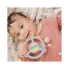 JuJuBe Silicone Teether Ring with Detachable Clip - Happy Baby Vibes - in use