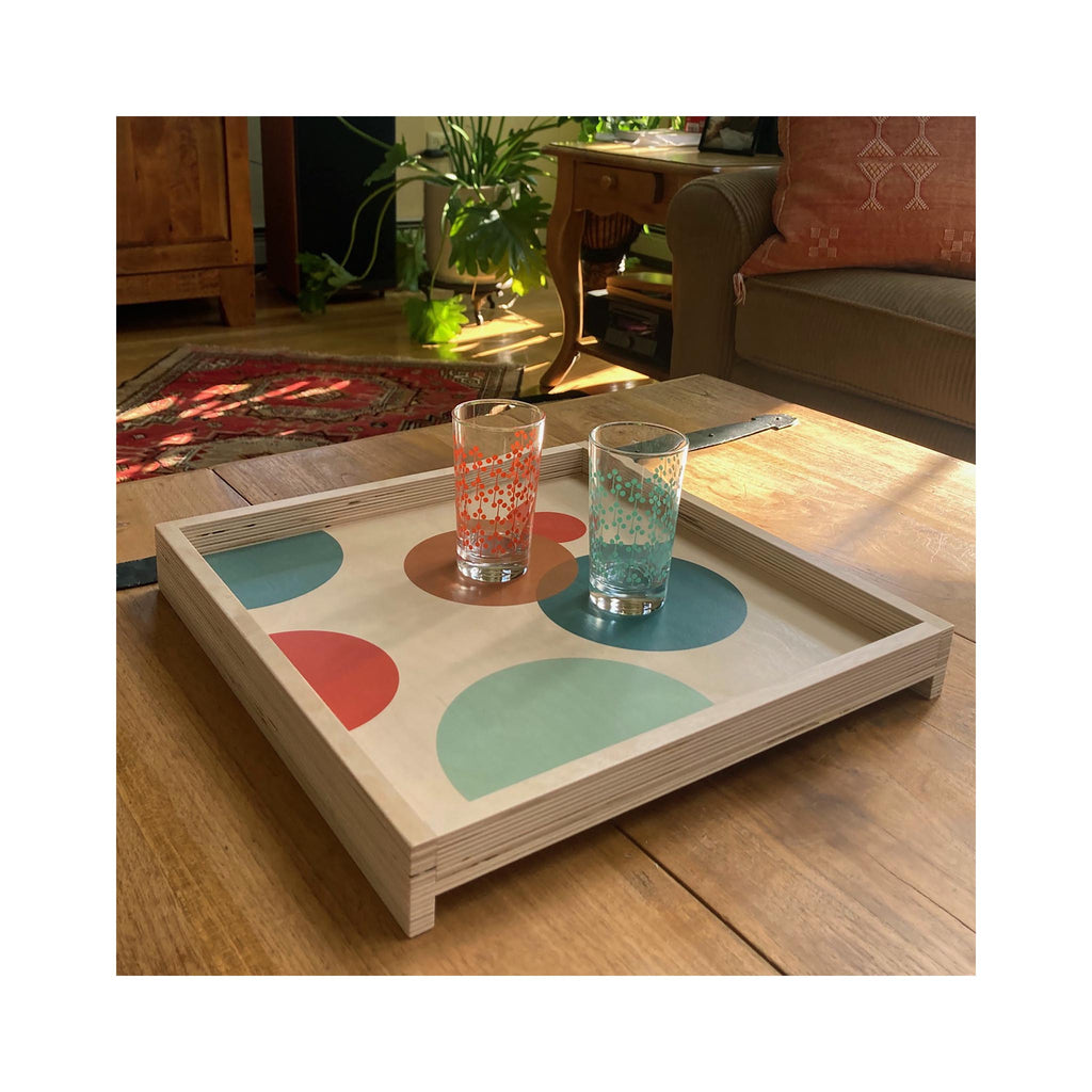 LAMOU Printed Baltic Birch Serving Tray - Circles - Grey, Gold, Orange, Teal - on table