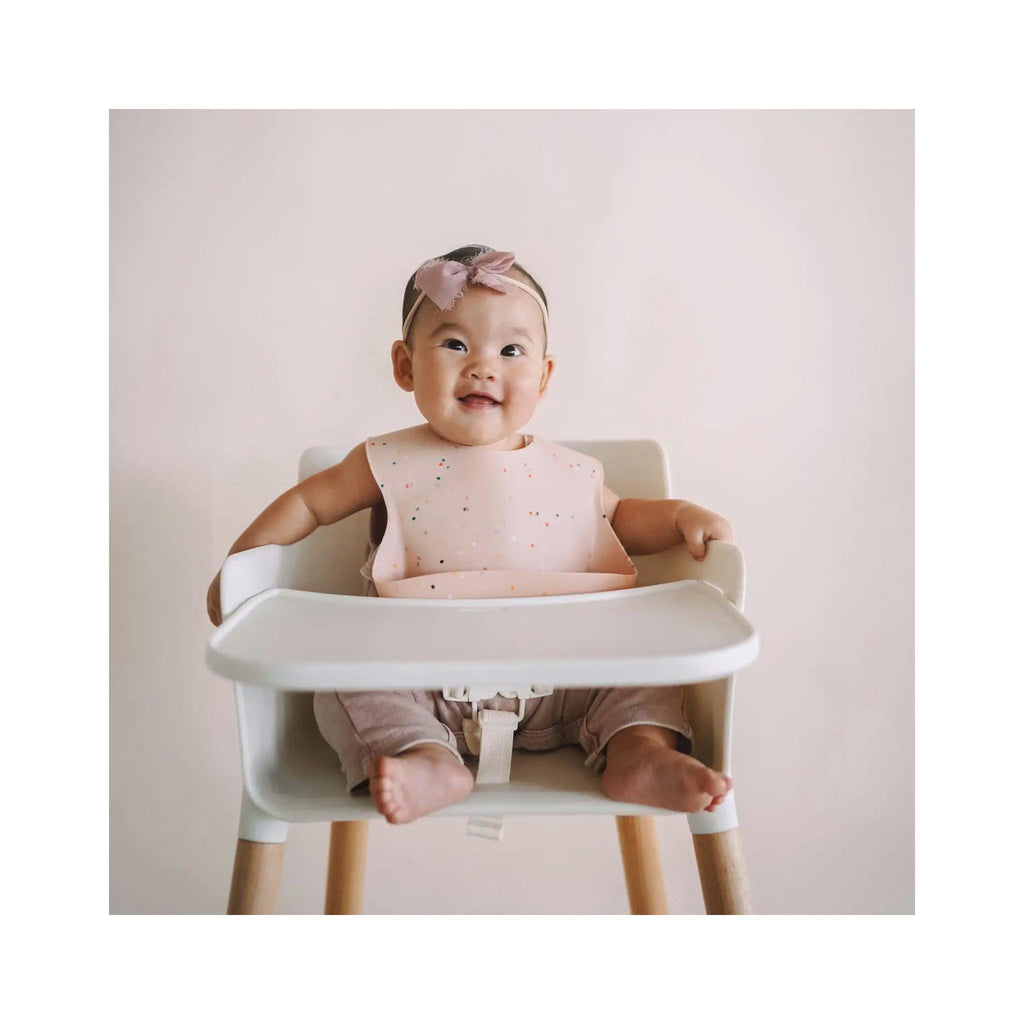 Ava + Oliver Confetti Silicone Baby Bibs - Guava on baby